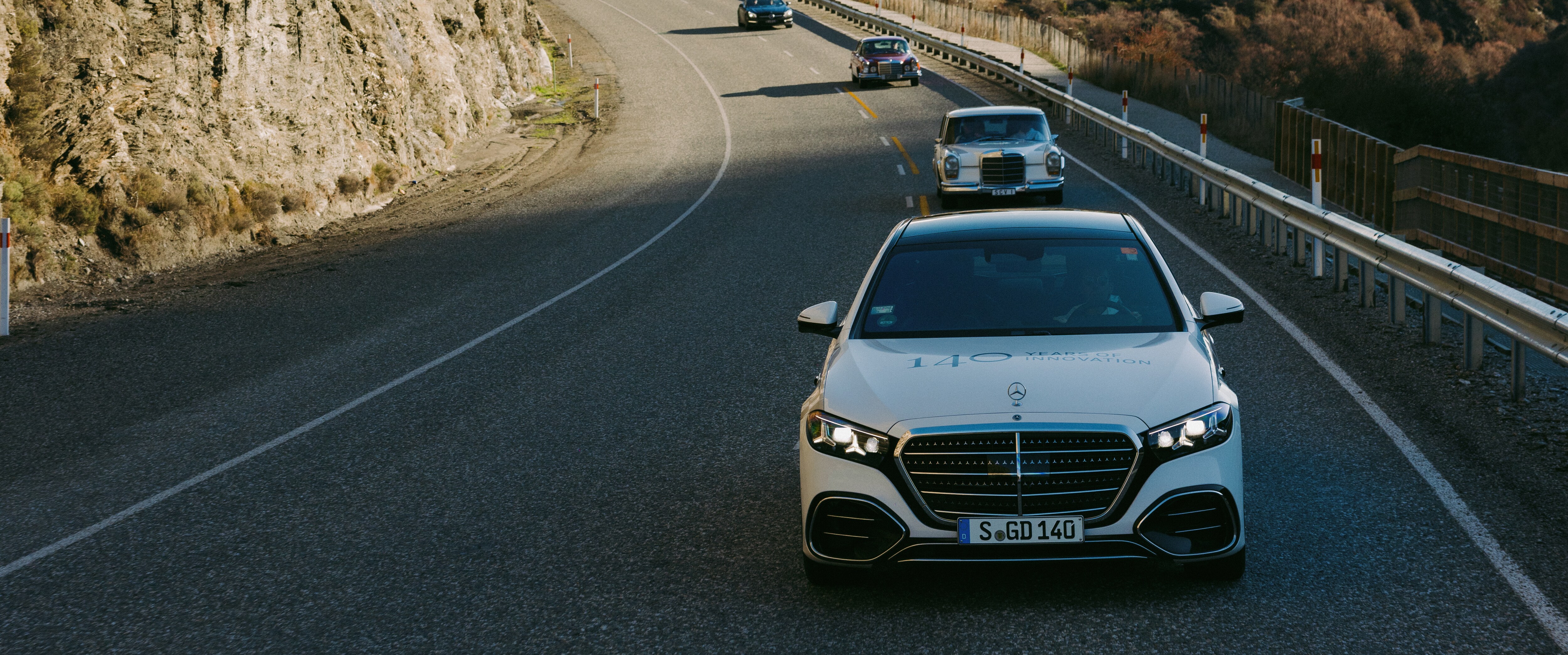 A convoy of cars driving down a road Image credit/photographer: Nik Muller