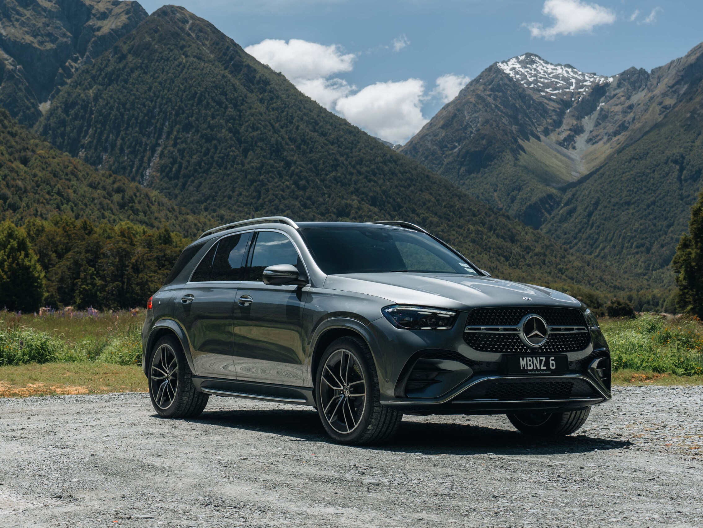 A Mercedes-Benz GLE SUV parked in front of a mountain range. Image credit/photographer: Andrei Diomidov