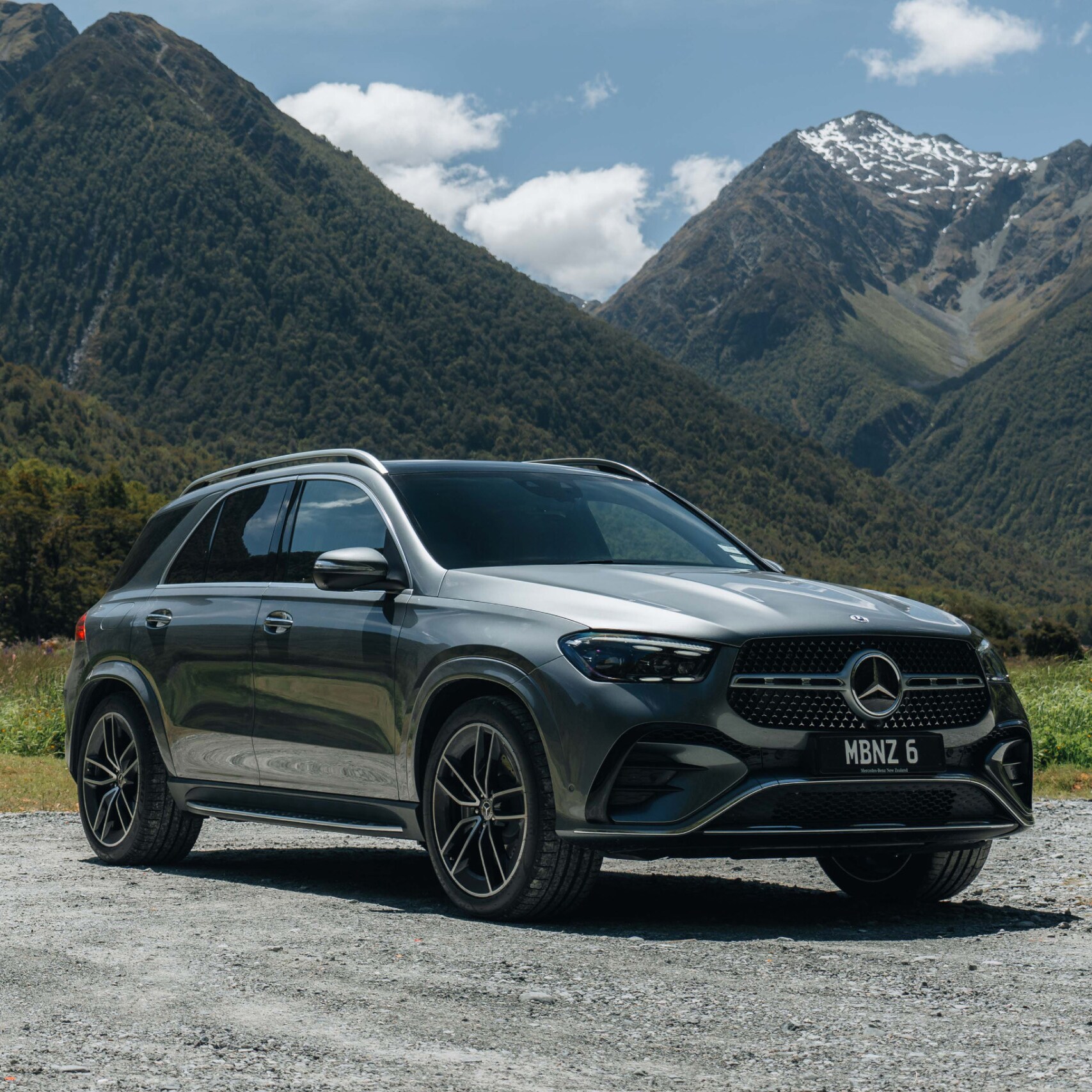 A Mercedes-Benz GLE SUV parked in front of a mountain range. Image credit/photographer: Andrei Diomidov