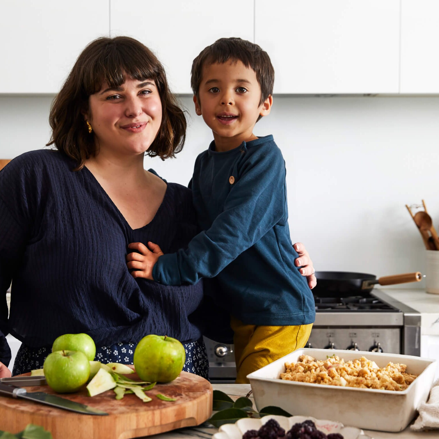 Julia Busuttil Nishimura and her son Haruki in their kitchen with apple crumble ingredients in front of them
