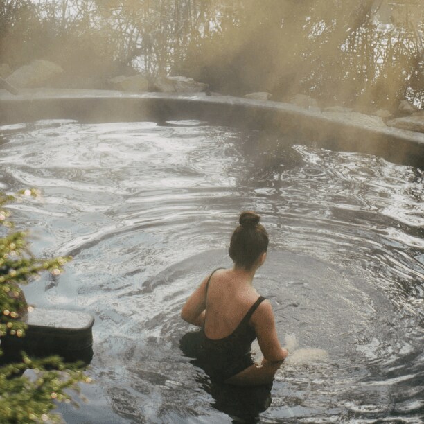 A woman sitting in hot springs