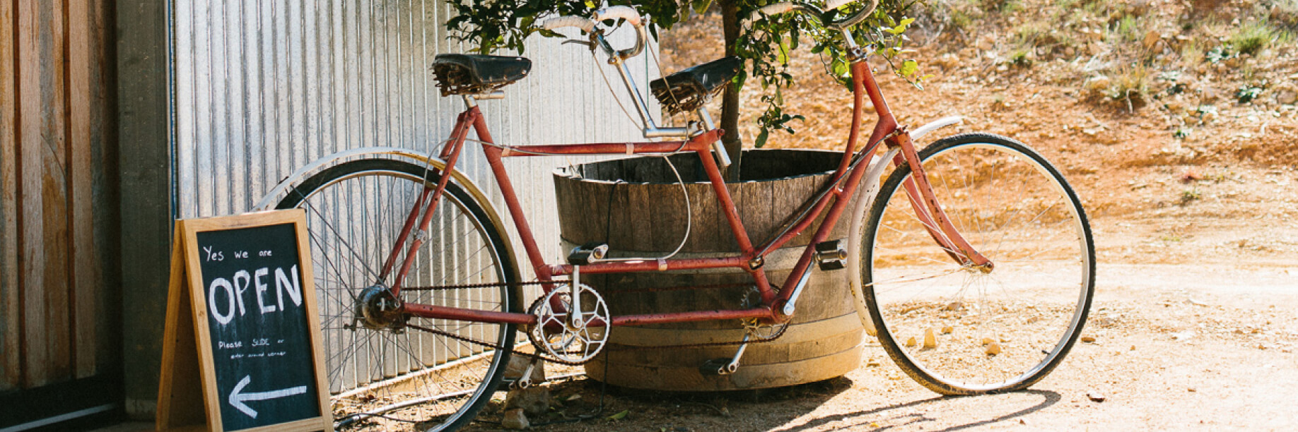 Red Feet Wines A bicycle in front of a winery cellar door