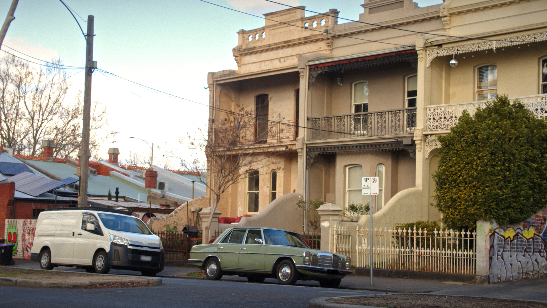 vintage Mercedes-Benz parked outside a townhouse A vintage Mercedes-Benz parked outside a townhouse