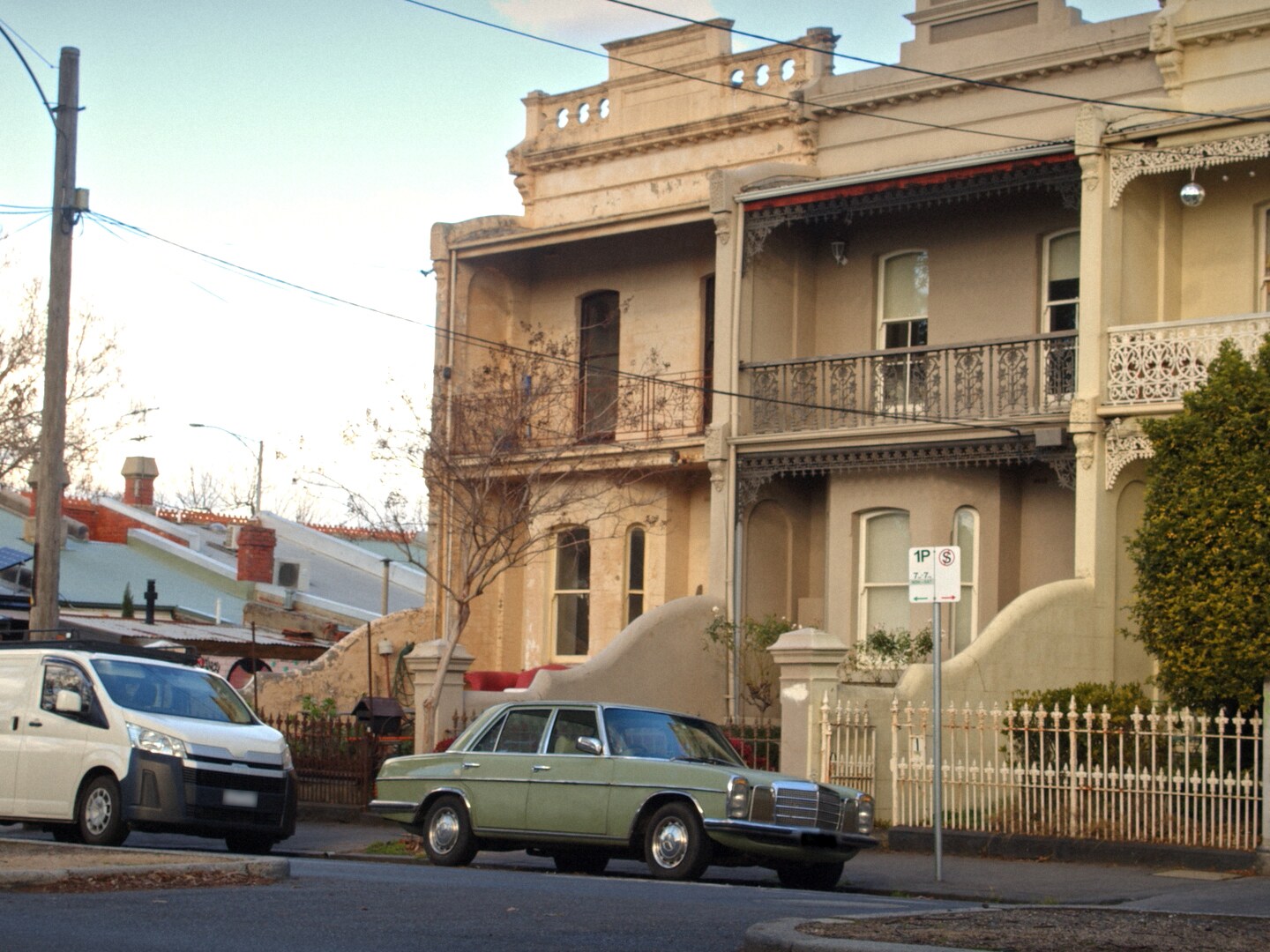  A vintage Mercedes-Benz parked outside a townhouse