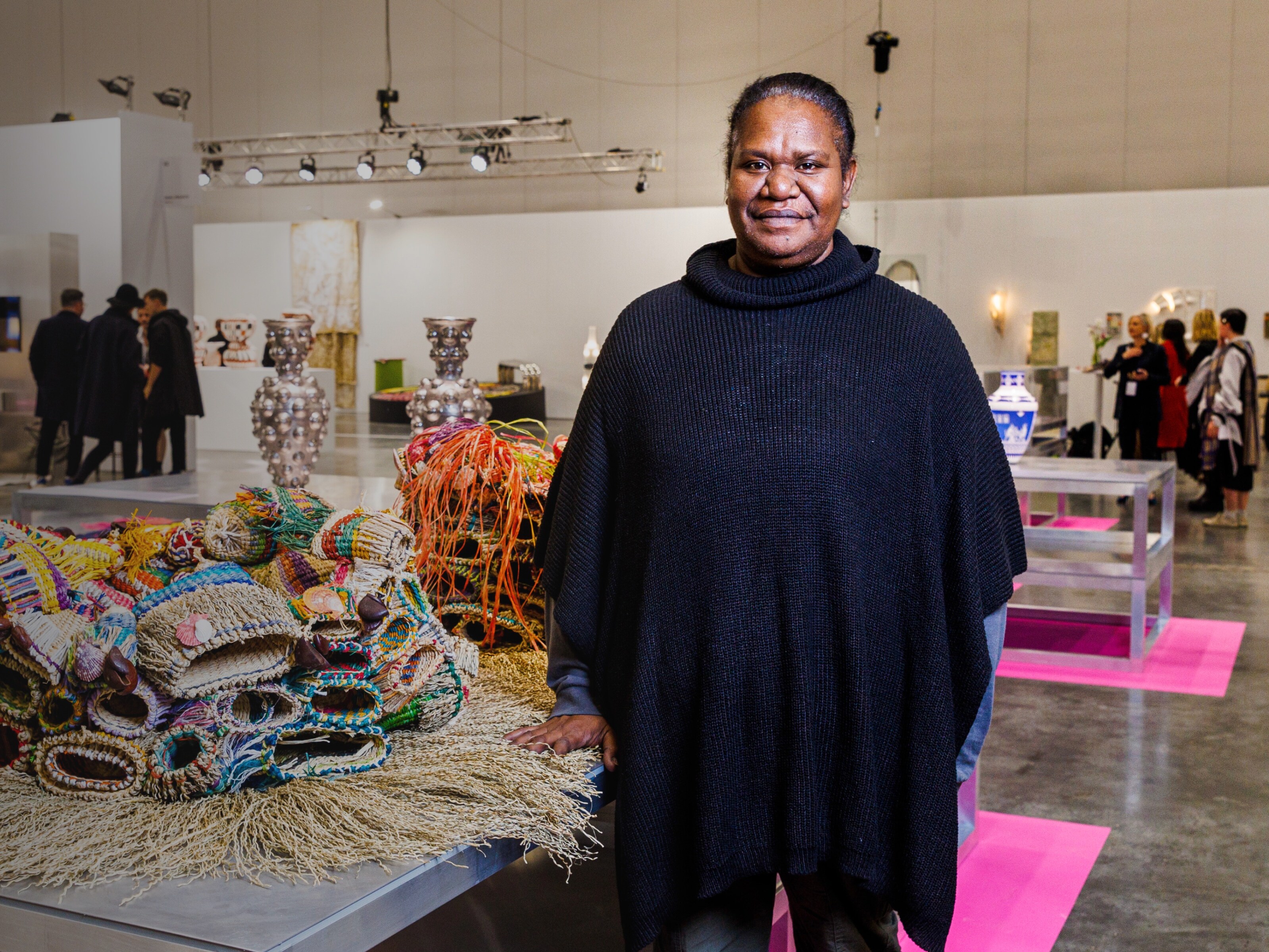 Mualgal artist Paula Savage stands in front of her work at Melbourne Design Week 2023. Image credit/photographer: Aaron Francis