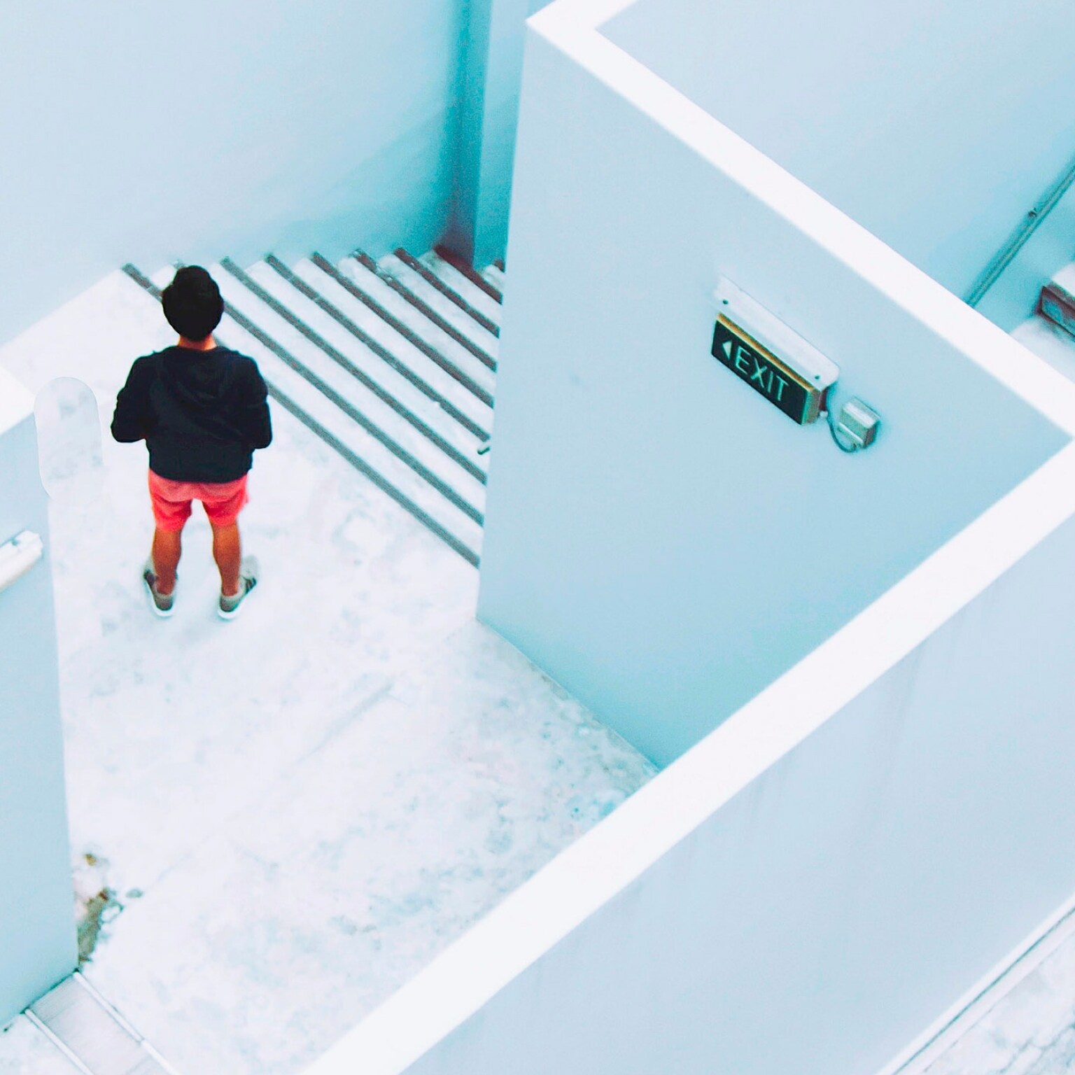 A person standing in a staircase shot from above