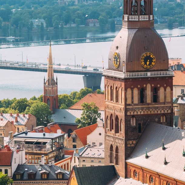 The Riga cityscape beside a river and a long bridge