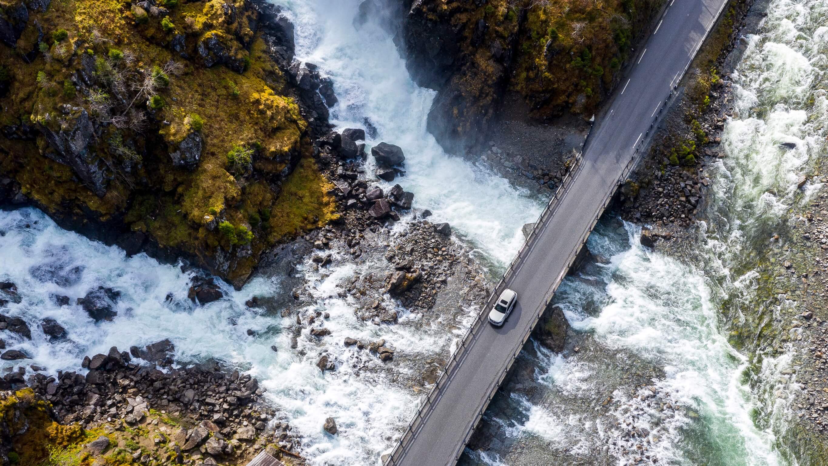 EQA 250 1 Aerial shot of Mercedes-Benz vehicle driving.