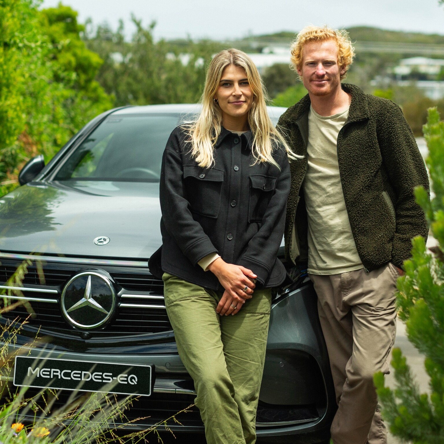 Jordy and Julia Kay smiling beside the EQC.