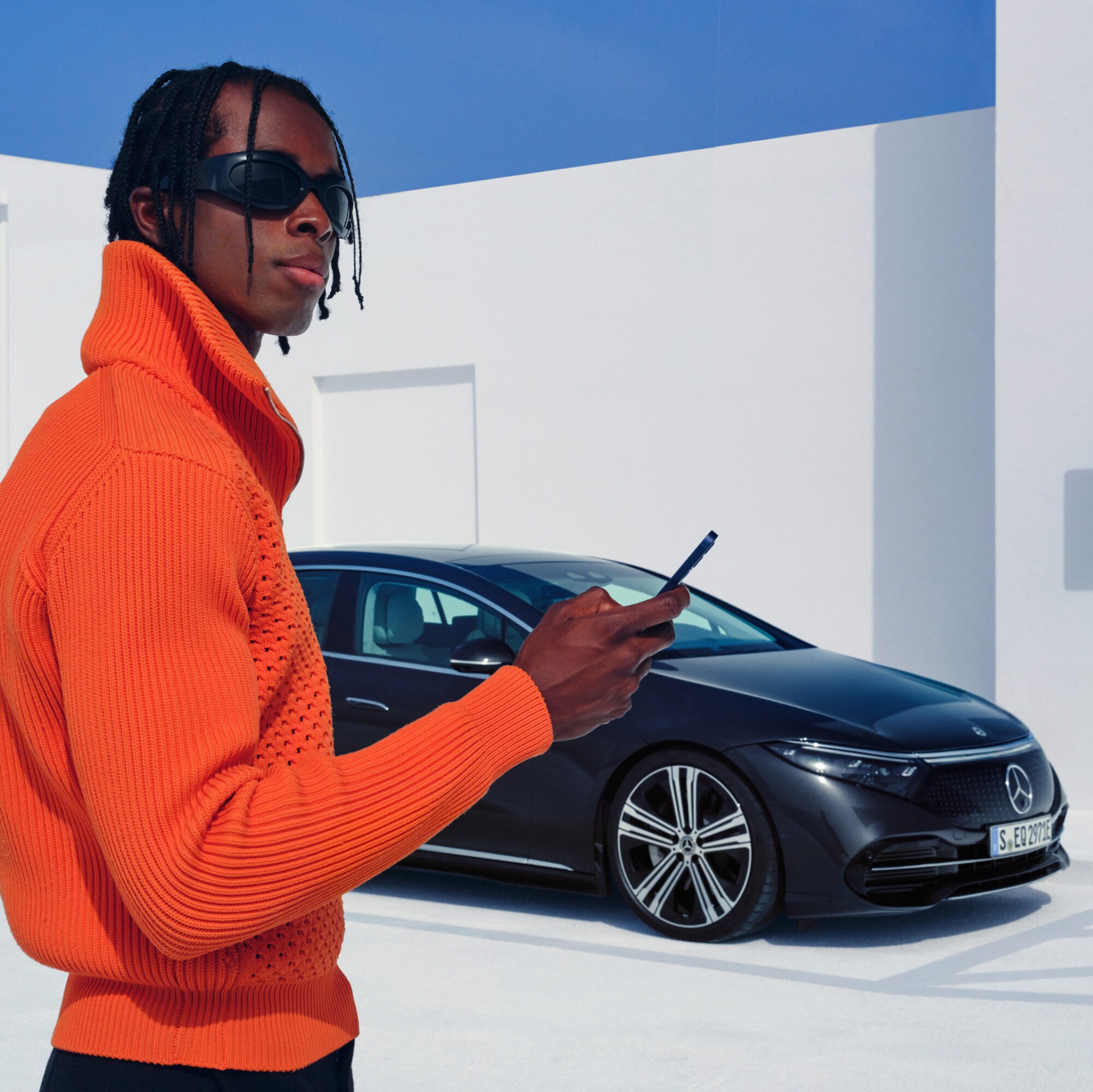 The image shows a guy holding a smartphone