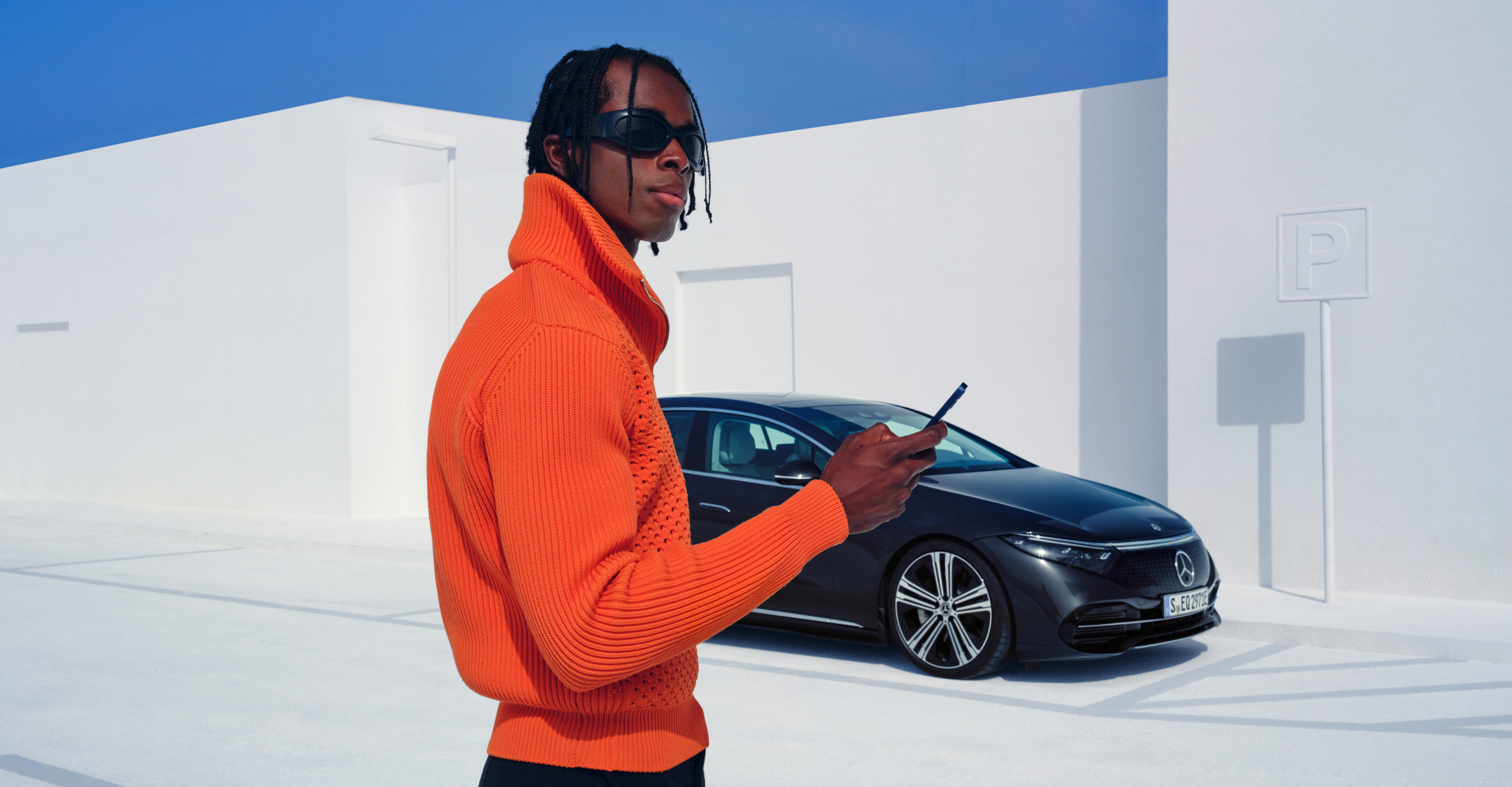 Mercedes me App The image shows a guy holding a smartphone