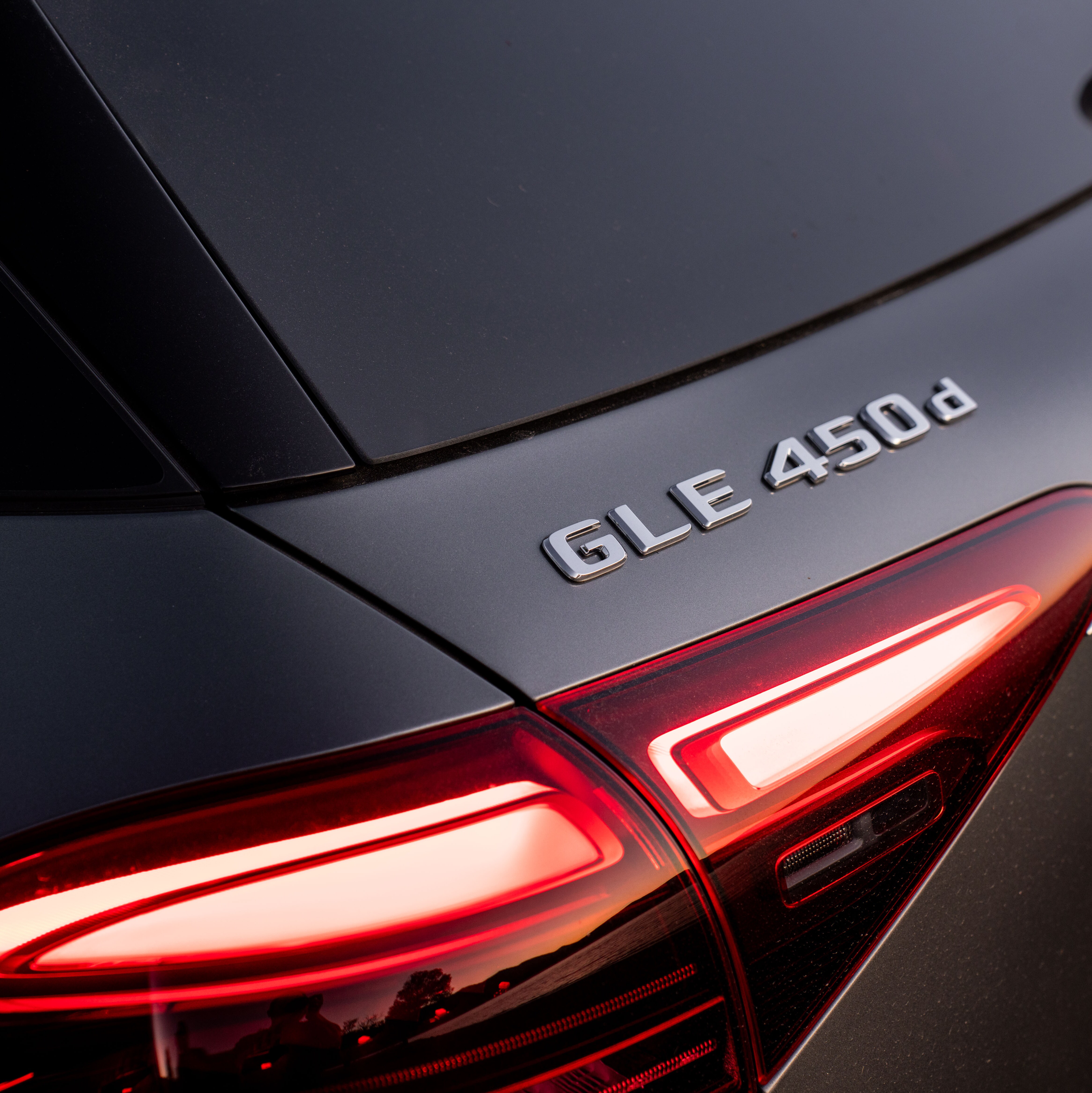 A close-up of the badge of a Mercedes-Benz GLE 450 d.