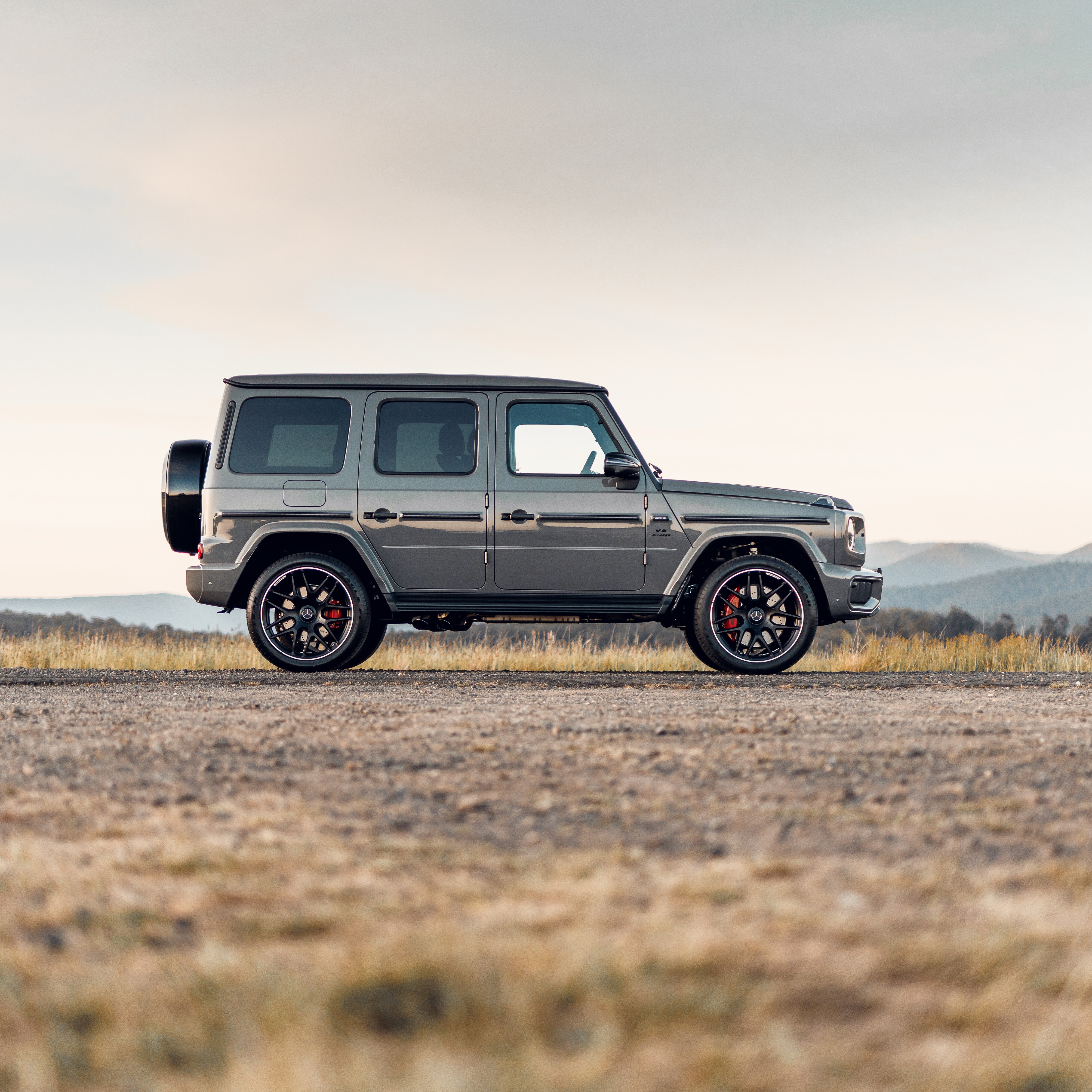 A Mercedes-AMG G 63 parked on gravel