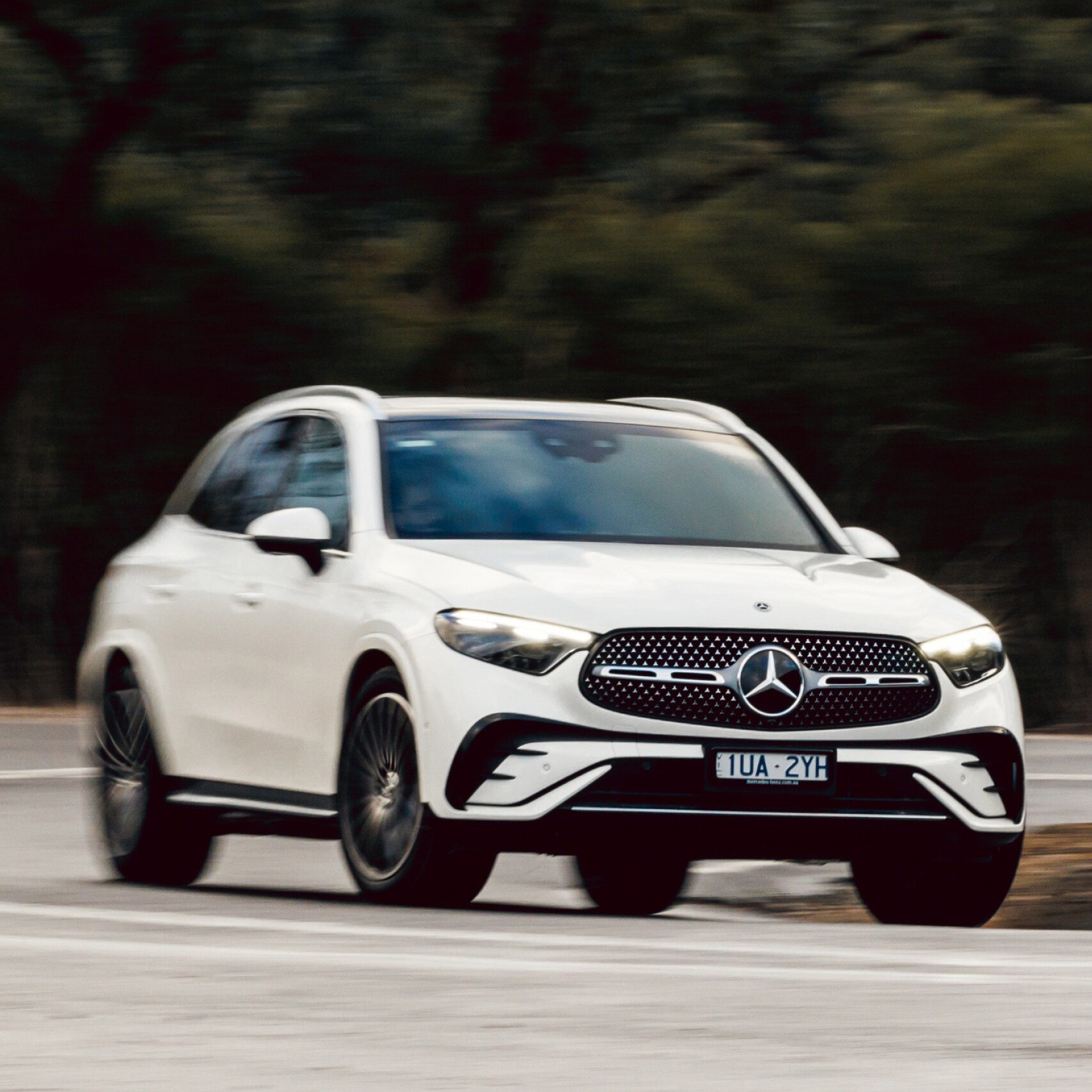 A white Mercedes-Benz GLC 300 4MATIC driving on a country road. Image credit/photographer: Stephen Dwight
