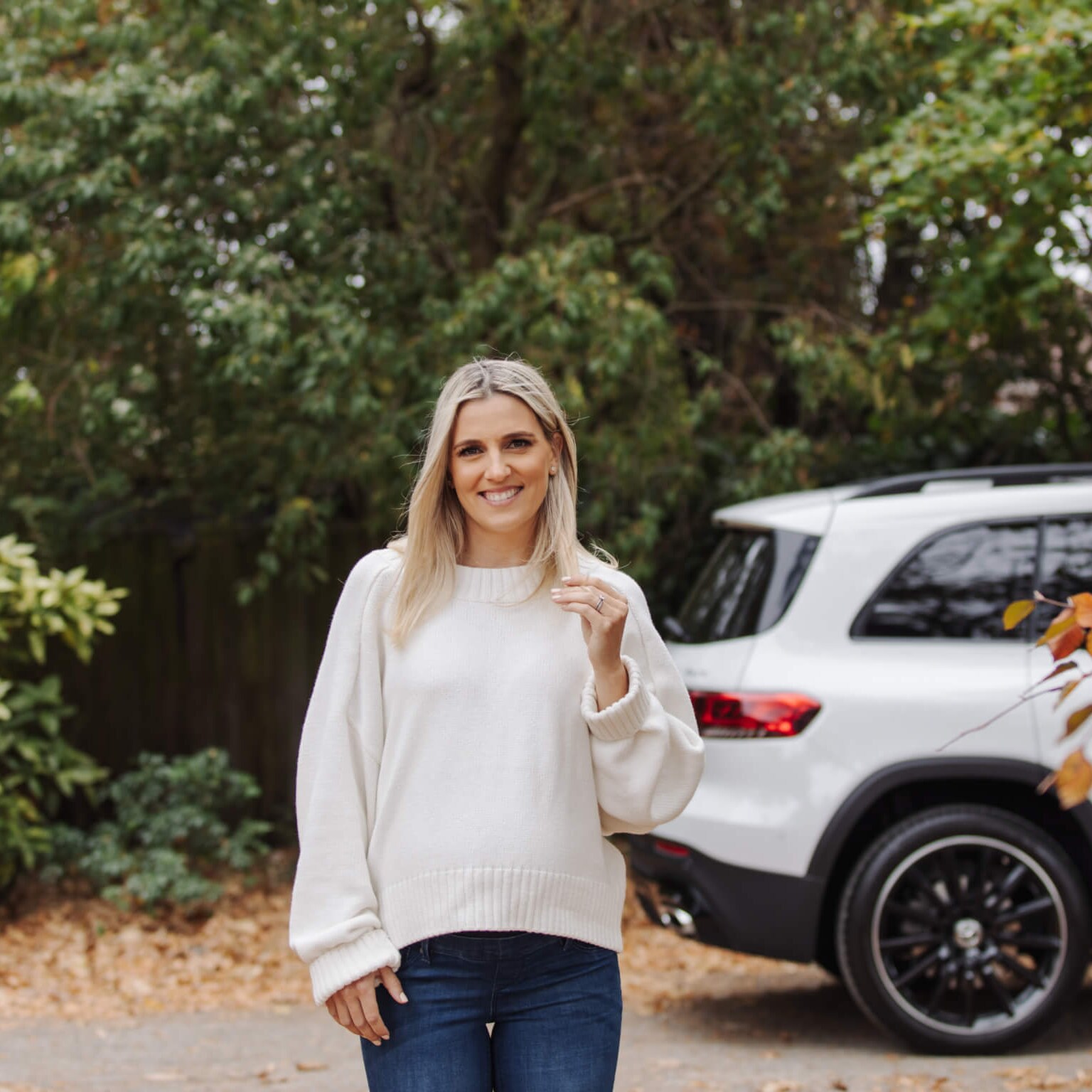 Gemma McCaw in front of a Mercedes-Benz vehicle.