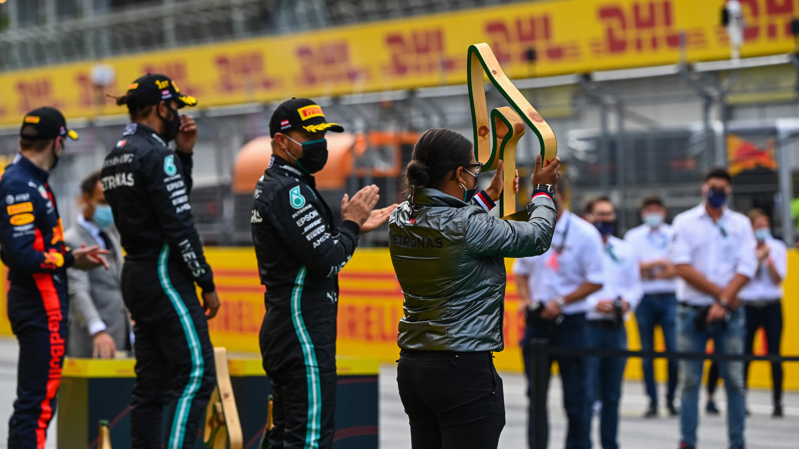 Stephanie Travers Stephanie Travers holds up trophy atop the F1 podium
