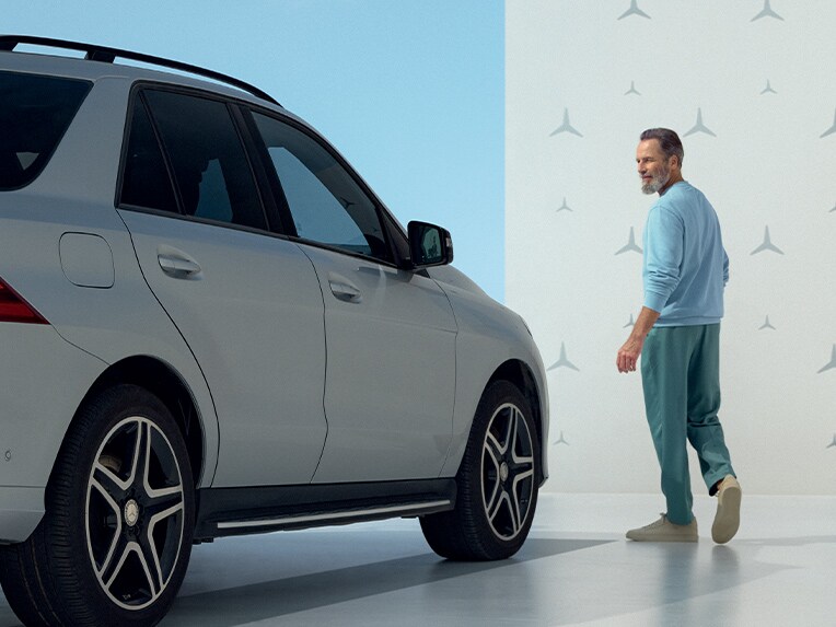 A person looking at their Mercedes-Benz.