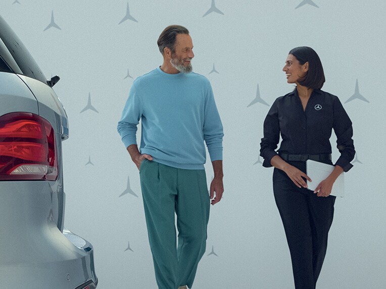 A customer and representative walking and talking.