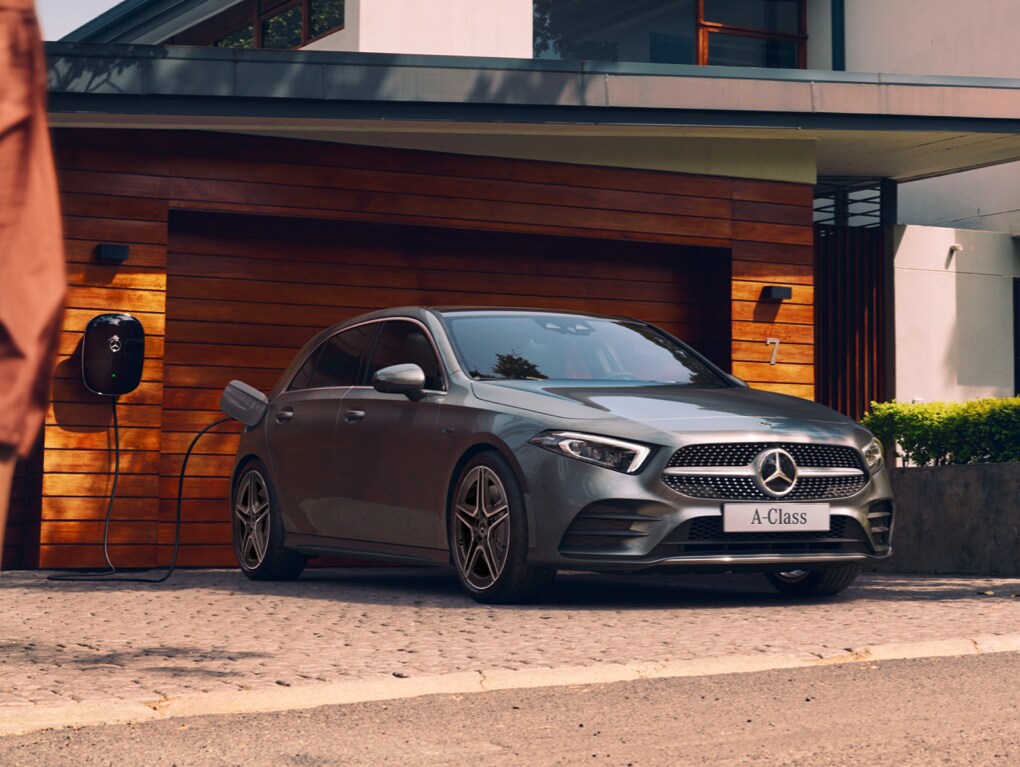 Mercedes-Benz A-Class charging in front of a garage