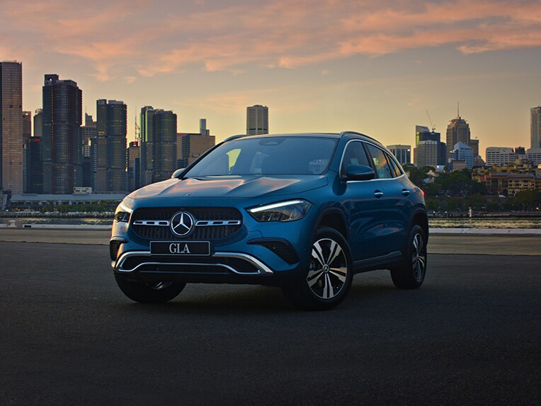 GLA City Edition SUV depict in front of a city background during sunset