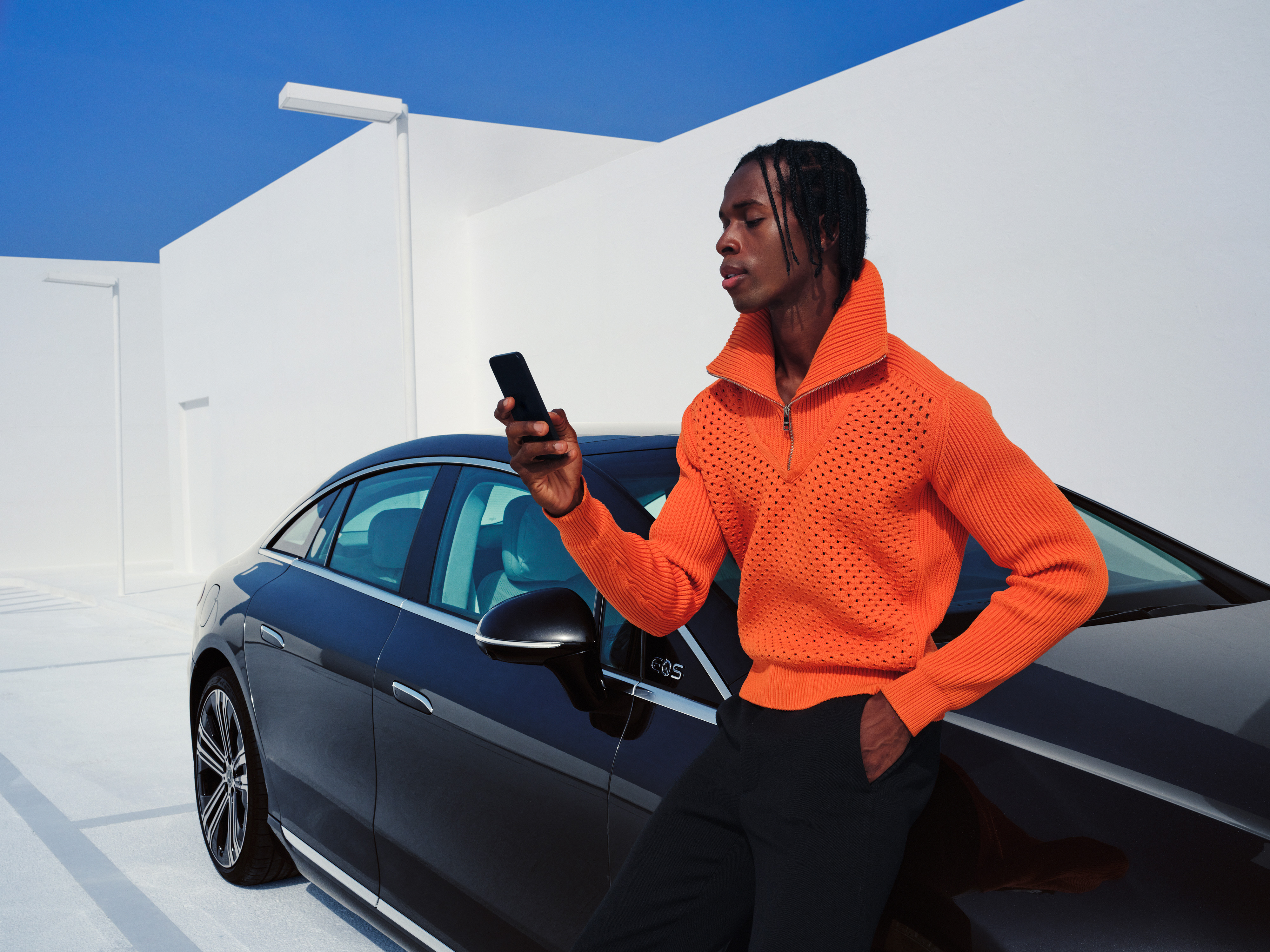A man connects his smartphone to his vehicle to use the Standard Services. A man connects his smartphone to his vehicle to use the Standard Services.