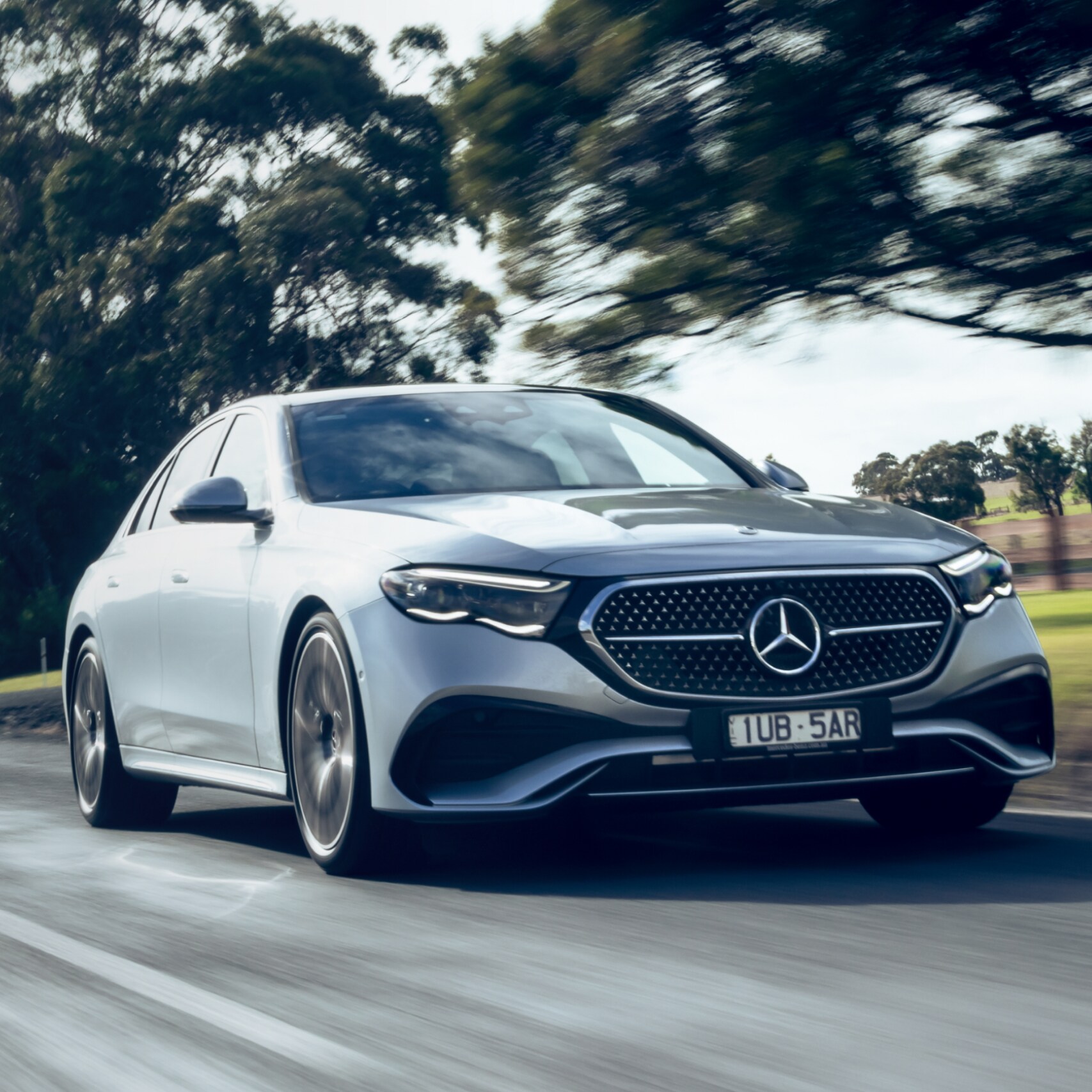 Mercedes-Benz E-Class Sedan driving on a road