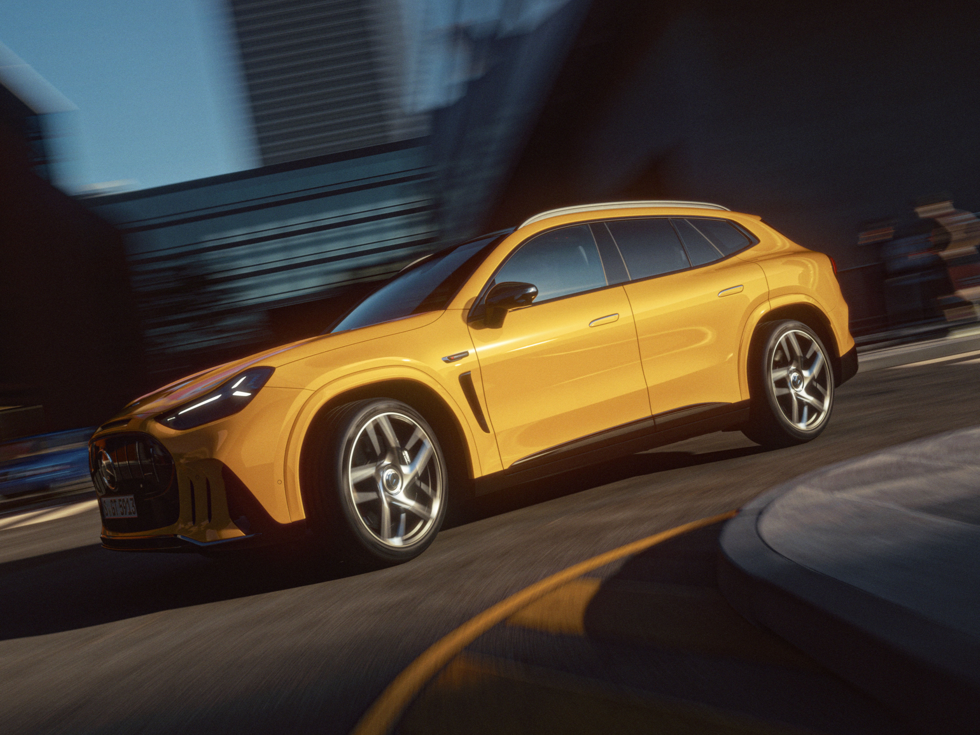 The all new Mercedes-AMG GT SUV parked on city street The all new Mercedes-AMG GT SUV is shown in profile on a city street, captured through a reflective window. The vehicle features large alloy wheels, sleek body lines, and tinted windows, suggesting a premium design. Urban buildings, traffic lights, and street elements in the background create a contemporary metropolitan setting. Warm sunlight enhances the metallic paint, giving the scene a polished, cinematic look.