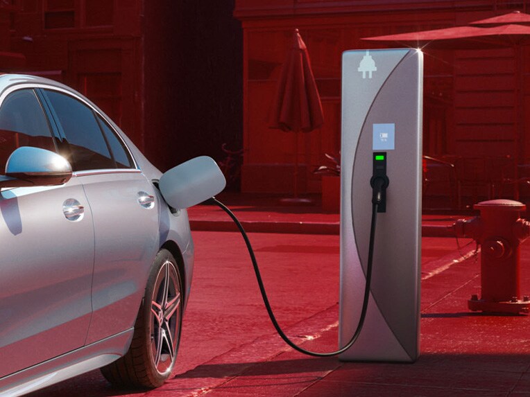 The Mercedes-Benz C-Class Sedan plug-in hybrid charging at a public charging station.