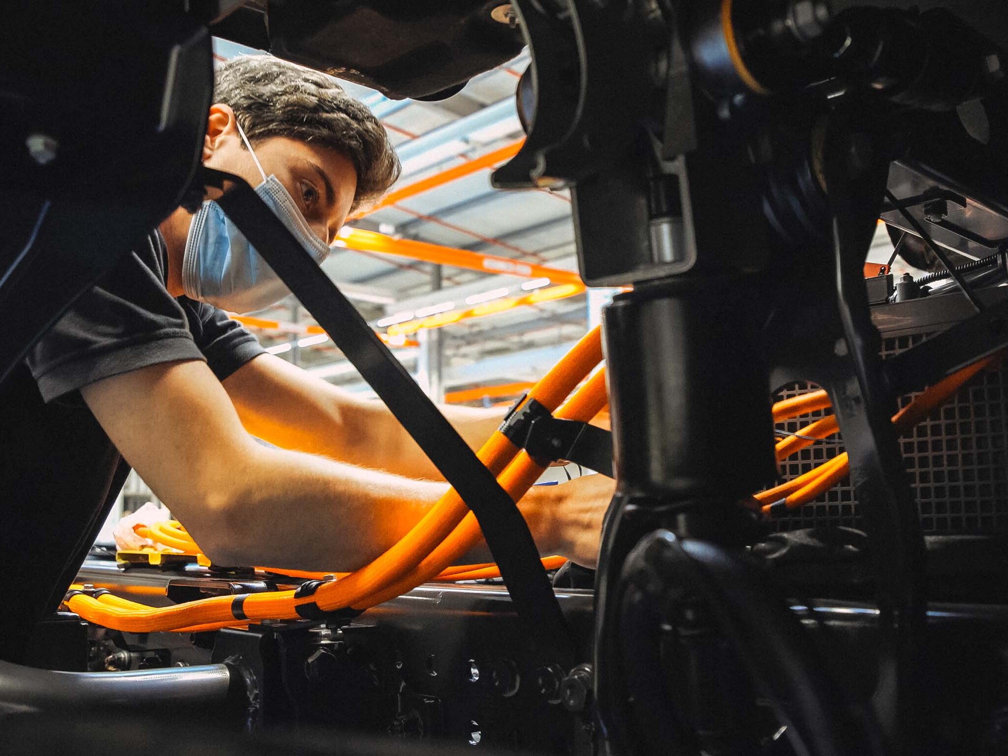 The image shows an employee at the production line.