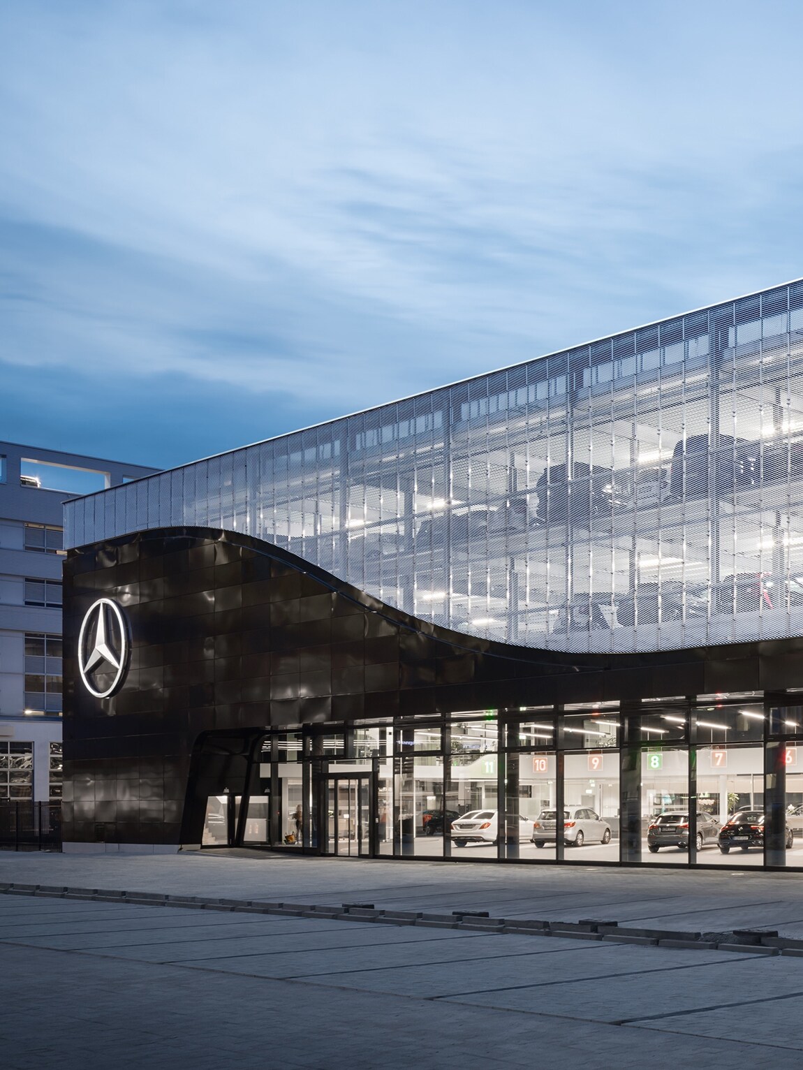 The image shows a service terminal of the Mercedes World in Berlin from the front.