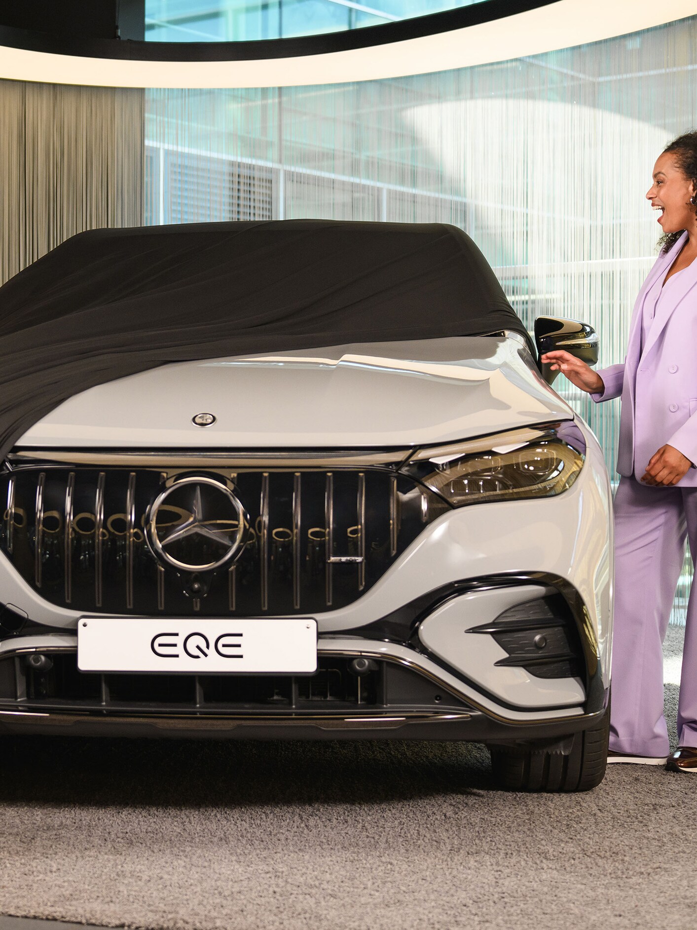 A person unveiling their new Mercedes-Benz.