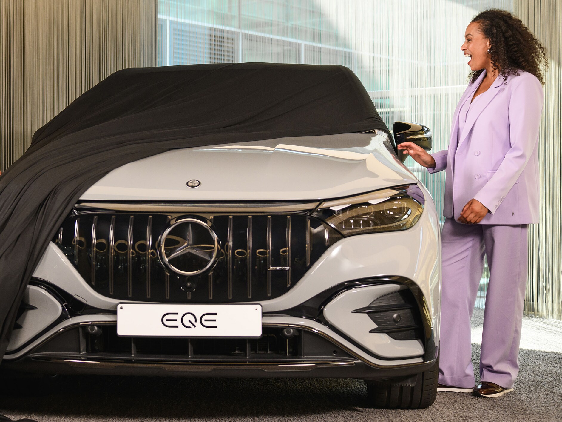 A person unveiling their new Mercedes-Benz.