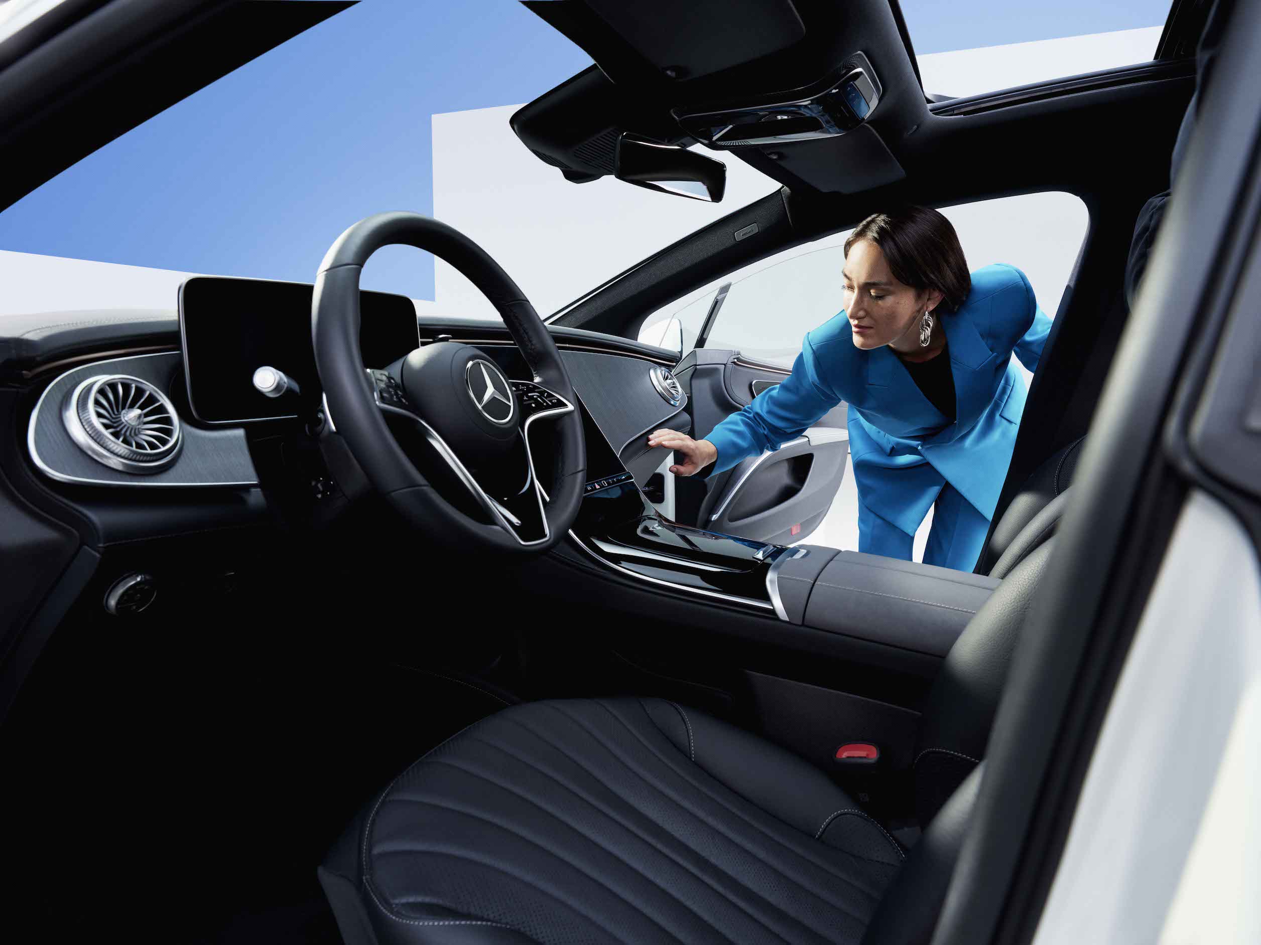 Mercedes-Benz | Genuine Car Care Products A woman inspects the clean vehicle interior of a Mercedes-Benz.