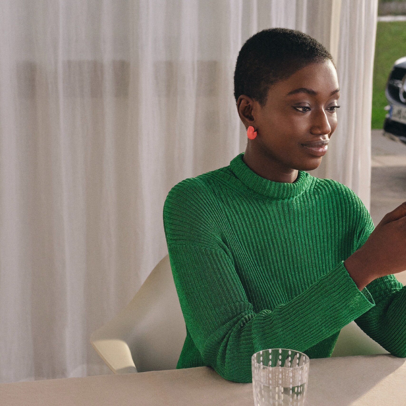 A woman checks the status of her vehicle on her smartphone.