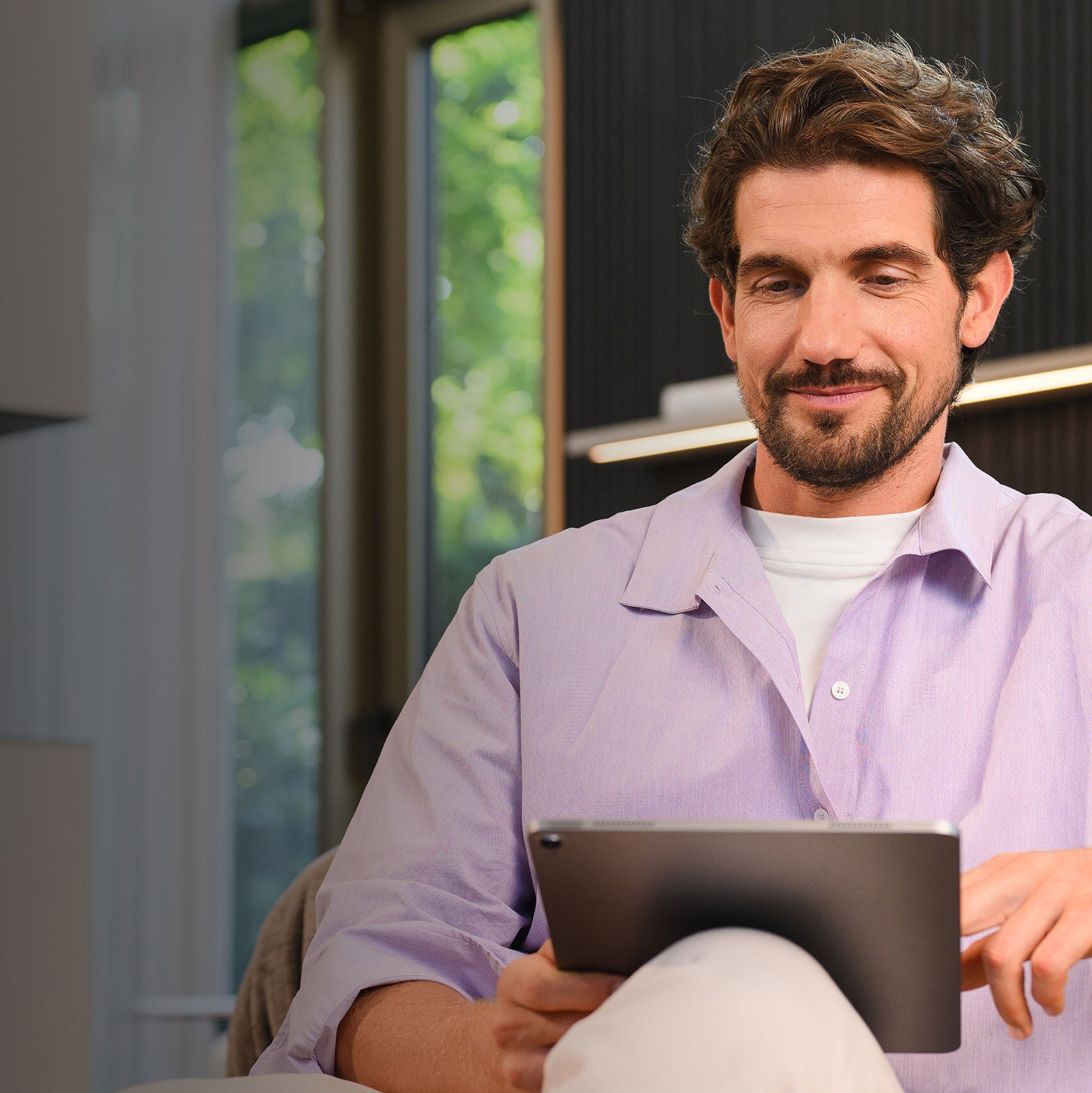 A person on their tablet browsing Mercedes-Benz finance products.