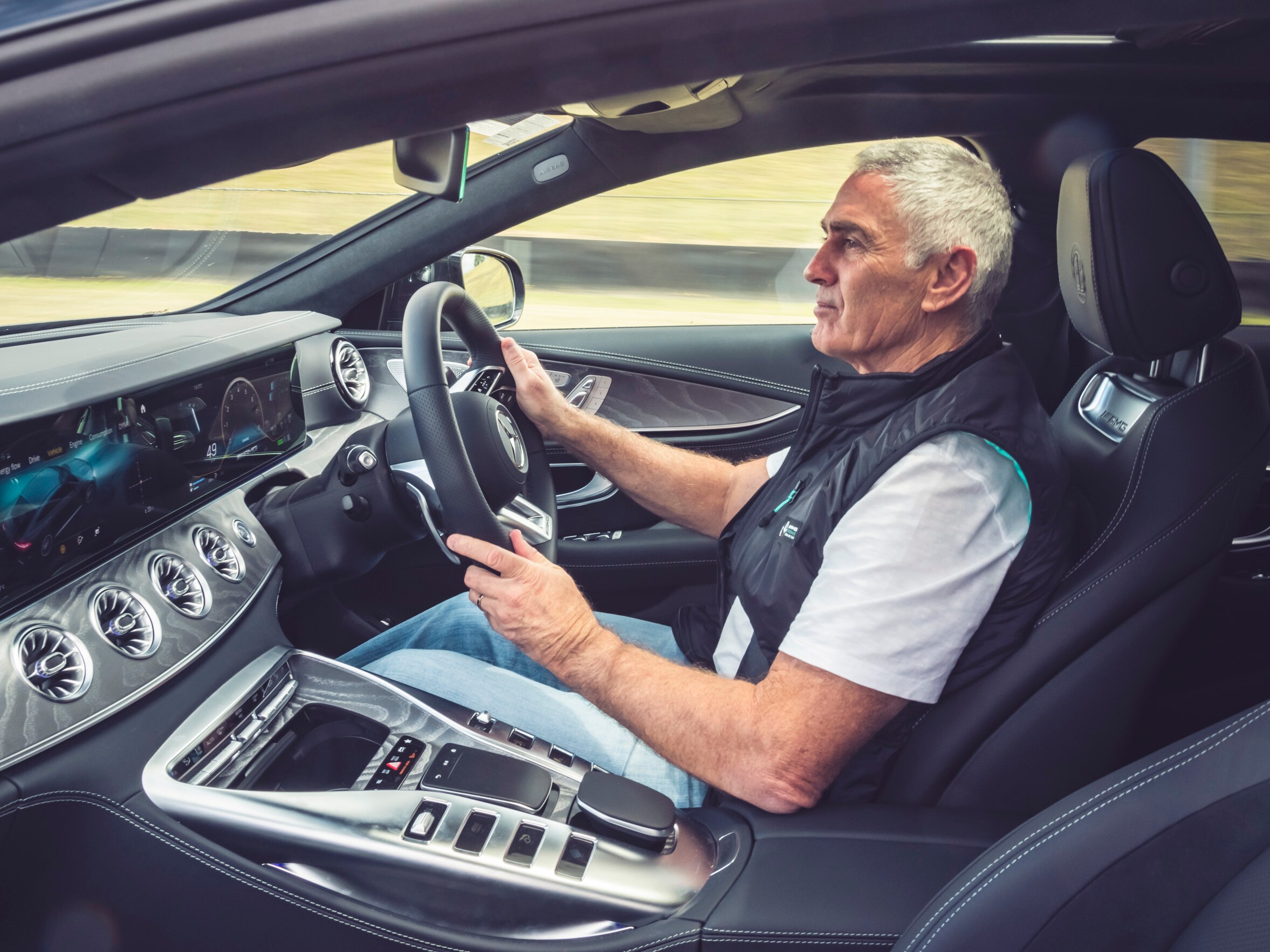 Mick Doohan sitting in the Mercedes-AMG GT 63 S E PERFORMANCE at Sydney Motorsport Park. 