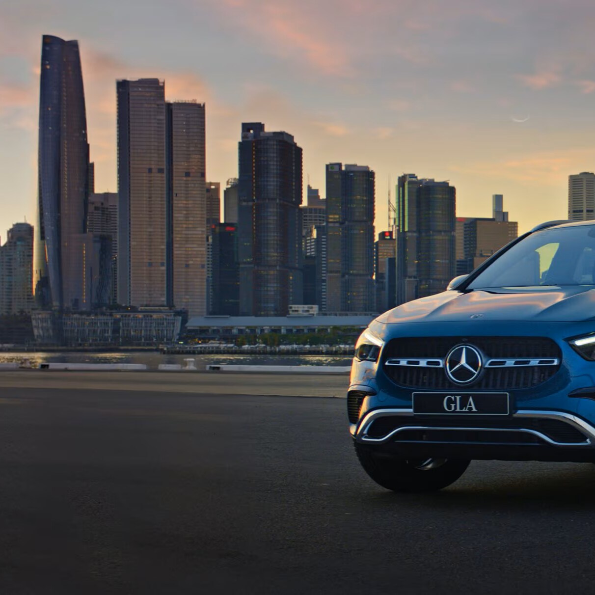 GLA City Edition SUV depict in front of a city background during sunset