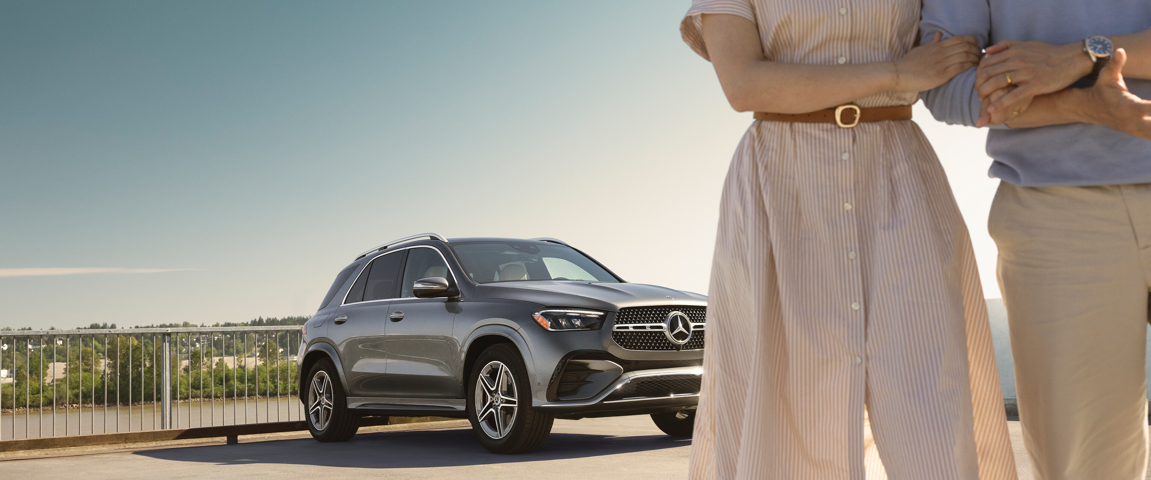 Mercedes-Benz SUV parked outdoors with two people partially visible in the foreground